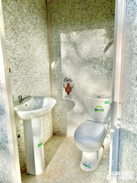 Interior of sustainable bathroom facility with bio digester system to reduce ecological footprint