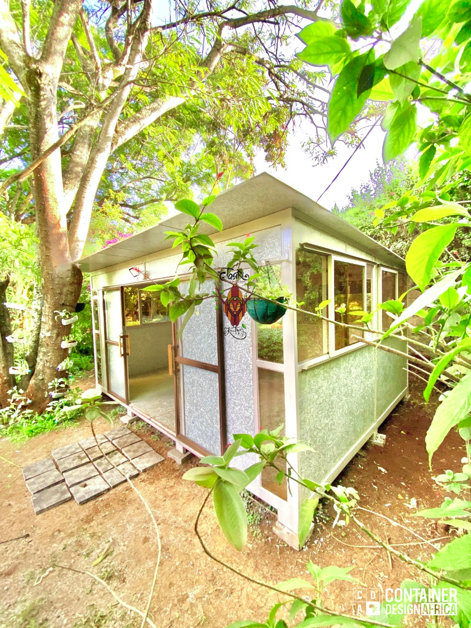 Jasiri's sustainable green classroom surrounded by lush vegetation, demonstrating integration with nature